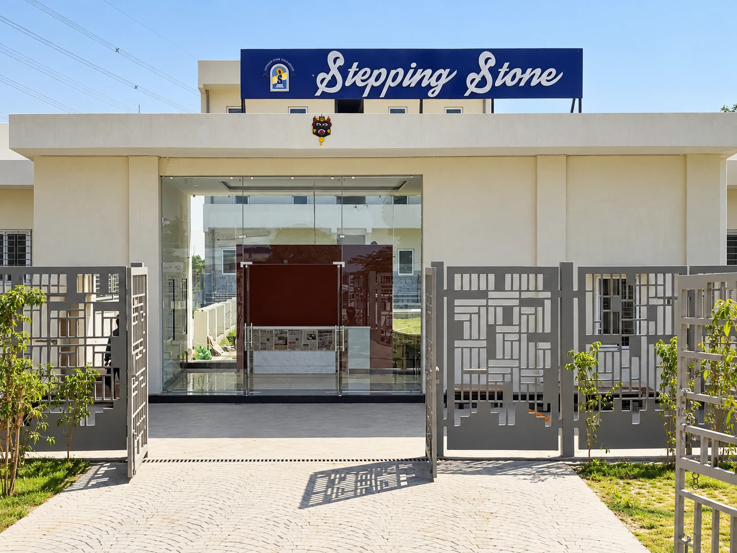 All Girls campus building, glass entrance, gates and Stepping Stone sign