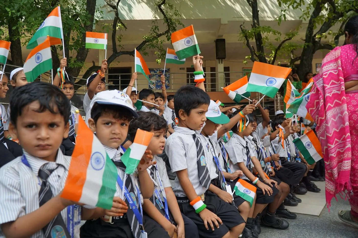 Young children holding Indian flags at a school celebration