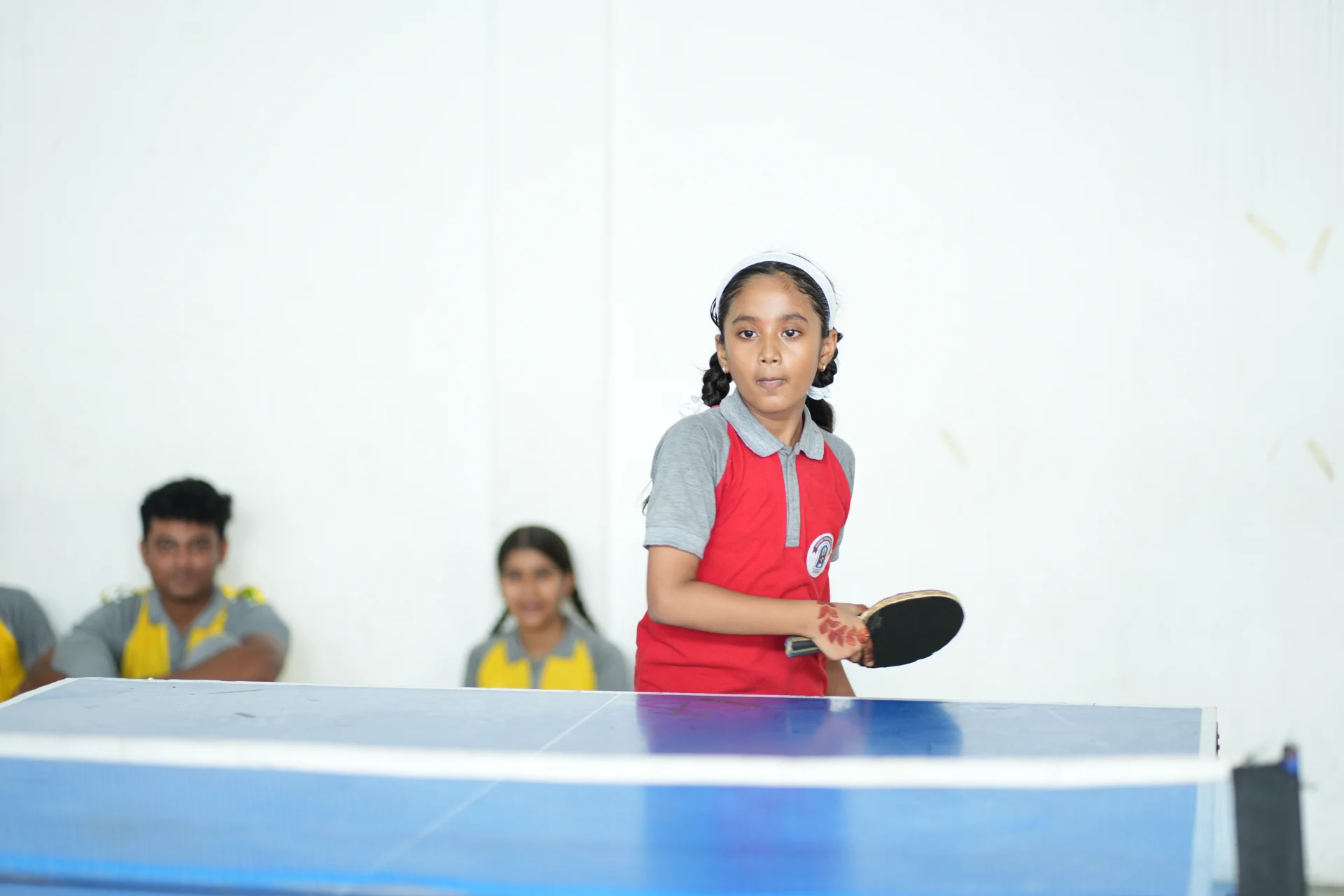 A pupil playing table tennis in the school activity space
